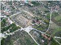 Aerial photo of the Archaeological Site of Ancient Corinth. From left to right: Lechaion Road, Temple of Apollo, Archaeological Museum, Odeion