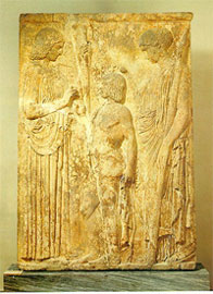On the left, goddess Demeter stands, who delivers to the hero Triptolemos(middle) the sacred grains under the blessing of Persephone (right)
