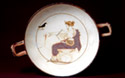 Interior of an white kylix with Apollon representation